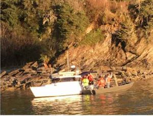 A Coast Guard Station Juneau Response Boat-Medium crew assists a 22-foot vessel taking on water in Auke Bay, Alaska, May 7, 2018. The Coast Guard boat crew delivered a dewatering pump to the 22-foot vessel, but after multiple attempts and a fast rate of flooding, the owner had to cease dewatering operations and was taken to Auke Bay Harbor. U.S. Coast Guard photo.