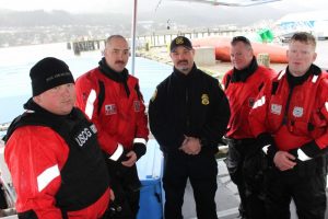 Crewmembers from the Coast Guard Cutter John McCormick pose with National Oceanic and Atmospheric Administration enforcement officer Tim Coffey. U.S. Coast Guard photo by Lt. j.g. Hailey Thompson.