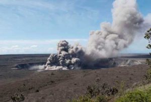In this May 11, 2018, photo released by the U.S. Geological Survey, a weak ash plume rises from the Overlook Vent in Halema'uma'u crater of the Kilauea volcano on the Big Island of Hawaii.