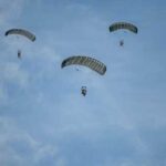 Paratroopers from the U.S. Army and Air Force execute a military free fall into a drop zone at La Fiere, France, June 07, 2026. D-Day 82 commemorates the courage and sacrifice of Allied forces who fought for freedom, reminding us of the enduring strength of alliances and shared responsibility. (U.S. Air Force photo by Tech. Sgt. Shawn White)