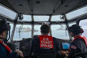 A U.S. Coast Guard long-range interceptor boatcrew from the Legend-class cutter Midgett (WMSL 757) monitors boarding team members conducting a law enforcement boarding of a fishing vessel. (U.S. Coast Guard Photo by Petty Officer 3rd Class Austin Wiley)
