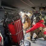 A G Company, 2-211th General Support Aviation Battalion, HH-60M Black Hawk crew chief hoists a hiker stranded on Matanuska Peak July 2, 2026. The rescue required the hoist-capable helicopter due to the vertical terrain. (Courtesy photo)