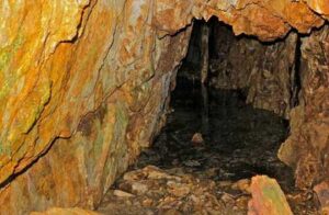 Photo:  Entrance to historic hard rock mine near Shakmanof Cove, Kodiak Island, Alaska. AM710.