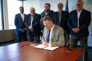 Governor Dunleavy pictured with members of the House Majority while signing the FY 2025 budget bills. 