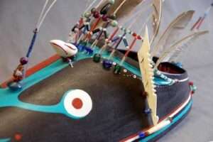 Photo: An ivory bird carving decorates a bentwood hunting visor, by Jacob Simeonoff. KANA collection. AM56.2.