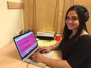 Photo: Rebecca Pruitt edits audio files at the Alutiiq Museum.