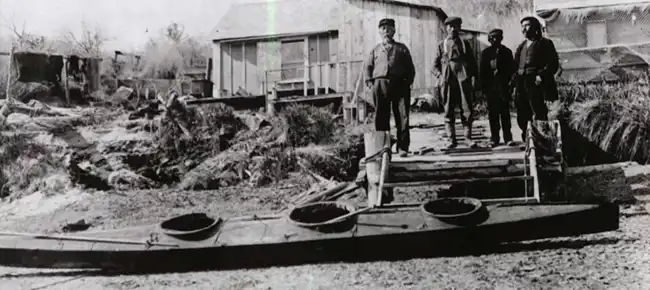 Alutiiq men with a three-hatched kayak, Uganik Village, ca. 1914. Photo by Dennis Winn, McCubrey Collection, Alutiiq Museum Library.