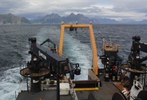 The Oscar Dyson departs a completed trawl location near the coastline of the Alaskan Peninsula. (Credit: NOAA)