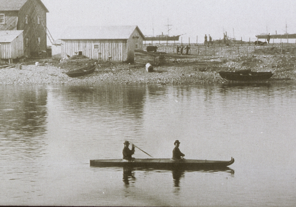 Two men in a two-man version of the Alutiiq kayak in Karluk Lagoon. Image-Alutiiq Museum