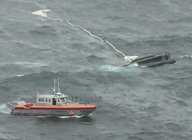 A Coast Guard 38-foot smallboat crew from Aids to Navigation Team Kodiak, Alaska, approaches the capsized Miss Destinee during a search for a missing man and woman in Marmot Bay near Kodiak. U.S. Coast Guard photo provided by Air Station Kodiak.