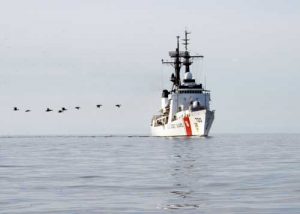 A line of birds crosses the bows of Coast Guard Cutter Sherman as crews return to the cutter in a small boat after conducting SAR and Kids Don’t Float training in Wainwright, Alaska July 14, 2017. The cutter visited several Arctic villages as part of Operation Arctic Shield 2017. U.S. Coast Guard photo by Chief Petty Officer John Masson.