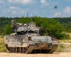 U.S. Army photo by Spc. Hector Blanco
A small unmanned aircraft system flies above an M2 Bradley Infantry Fighting Vehicle during Operation Return of the Condor on Fort Hood, Texas, Aug. 27, 2025. Operation Return of the Condor served as a testing ground for drone detection and tactics for countering small unmanned aircraft.