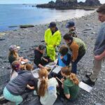 Kodiak campers share their findings from tidepooling on Fort Abercrombie Beach. Photo by Leigh Lubin/Alaska Sea Grant.