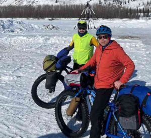 Photo by Ned Rozell Forest Wagner, left, and Ned Rozell pause in front of the tripod on the ice of the Tanana River at the town of Nenana. When the river ice breaks up and the tripod pulls a cable attached to shore, the person who guessed the time will win the Nenana Ice Classic.