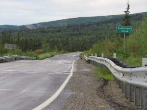 UAF photo by Sam Bishop
Ballaine Road exhibits bumps from permafrost thawing near where it crosses Goldstream Creek north of Fairbanks in July 2026.