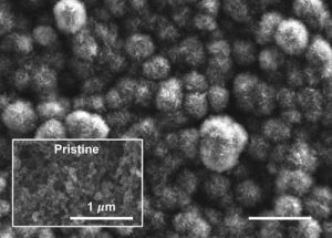 This scanning electron microscope image shows the carbon cathode of a carbon-dioxide-based battery made by MIT researchers, after the battery was discharged. It shows the buildup of carbon compounds on the surface, composed of carbonate material that could be derived from power plant emissions, compared to the original pristine surface (inset). Courtesy of the researchers