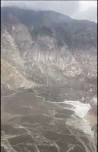 Image from video by Lt. Chip Baucom and Cdr. PJ Johansen, U.S. Coast Guard
Debris from an Aug. 10, 2025, landslide in Southeast Alaska spilled into Tracy Arm and onto South Sawyer Glacier. Dirt, rock and debris now fill an area of the fjord in the lower left of the photo.