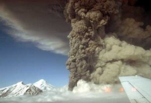 Photo courtesy of the Alaska Volcano Observatory
The Aug. 18, 1992, eruption of Mount Spurr volcano occurred at the mountain’s Crater Peak vent. A light tan cloud ascending from pyroclastic flows is visible at right. The summit lava dome complex at 11,070 feet is visible at left. Photo by R. McGimsey, U.S. Geological Survey.
