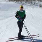 Hailey Swirbul, B.S. Civil Engineering ’21, pauses skiing to smile in front of a glacier. Photo courtesy of Hailey Swirbul.