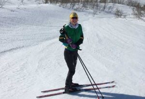 Hailey Swirbul, B.S. Civil Engineering ’21, pauses skiing to smile in front of a glacier. Photo courtesy of Hailey Swirbul.
