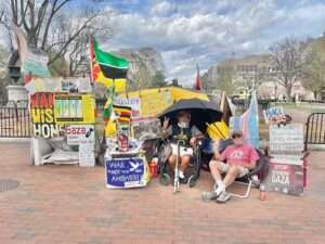 The White House Peace Vigil on March 30, 2025 staffed by volunteers, Philipos Melaku-Bello (left) and Joe Brown (right). Image-Public Domain