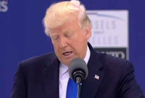 President Trump reading his speech at NATO. Image-VOA