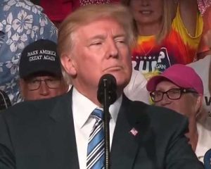Trump looking on as his supporters chant "Lock Her Up, Lock Her Up" at August 3rd,2017 W. Virginia rally