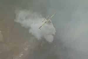 Aircraft dispersing fire suppression chemicals. Image-VOA