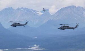 Two U.S. Air Force rescue helicopters, a HH-60G Pave Hawk, left, and a HH-60W Jolly Green II, both assigned to the 210th Rescue Squadron, 176th Wing, Alaska Air National Guard. (Alaska National Guard photo by Alejandro Peña)