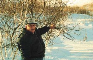 Photo: Victor Melovedoff holding alder branches. Photo by Priscilla Russell, KANA Collection.
