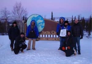 From left, Ryan West, Shawn Freitas, John Whittington, Doug Morrow, Bernie Tao, Darrin Marshall, and Andy Soria pose at the Arctic Circle pull-out on the Dalton Highway, where they camped in March 2009 to test the cold-weather performance of “Permaflo Biodiesel.” Photo courtesy Darrin Marshall.