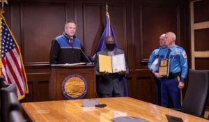 Governor Dunleavy recognizes Alaskan resident Antoine Aridou for helping Trooper Laura Reid save the life of a 12-year-old boy. Col. Doug Massie and Commissioner James Cockrell presented Aridou with a Life-Saving Award.