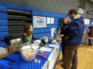 Alaska Sea Grant Marine Advisory agent Torie Baker speaks with fishermen in Cordova, Alaska, in 2015 about participating in a study about fishermen’s health led by a University of Washington researcher Debra Cherry, MD. Image-ASG