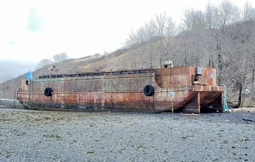 Coast Guard, Contractors Respond to Pollution Threat from Derelict Barge on Kodiak Island