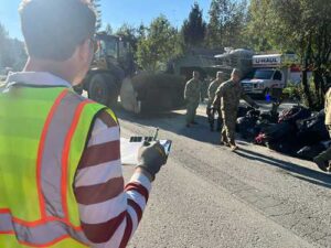 Solid waste staff member assisting Alaska National Guard with waste screening.