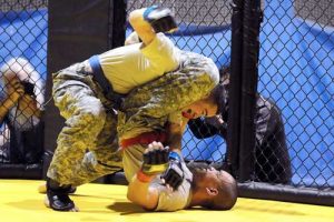 Spc. Sean Blinco (blue) takes a shot at Spc. Augusto Juarez during U.S. Army Alaska's 2013 Staff Sgt. Jacob G. McMillan Combatives Tournament March 22 in the Buckner Physical Fitness Center on Joint Base Elmendorf-Richardson, Alaska. The two-day tournament was held to select USARAK's best fighters in eight weight classes. Blinco won the match to finish first in the flyweight class. (U.S. Army photo/John Pennell)