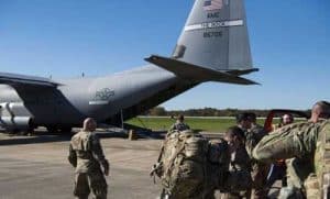 Deployers from Headquarters Company, 89th Military Police Brigade, Task Force Griffin getting ready to board a C-130J Super Hercules from Little Rock, Arkansas, at Fort Knox, Kentucky. This Oct. 29, 2018 photo provided by the U.S. Air Force.