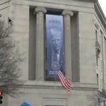 Enormous ‘Dictatorship-Style’ Banner With Trump Face on Side of Justice Department. Image-NBC video screengrab