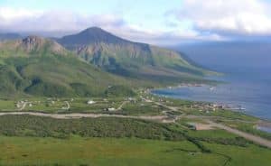 The City of False Pass, Alaska, looking north west towards the Bering Sea. The city is a seaport and fishing community located on Isanotski Strait at the mouth of a glacial valley leading east from Roundtop, an extinct volcano. Image-Shishaldin.licensed under the Creative Commons Attribution 3.0 Unported license.  