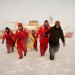(From left) Carl Felten, U.S. Coast Guard Ensign Annabelle Gagnon, Merchant Marine Academy Cadet Taylor Crisci, Luc Rainville and Jeremy Wilkinson pull a buoy across the Arctic ice Sunday, Sept. 30, 2018, about 350 miles northeast of Barrow. (NyxoLyno Cangemi/U.S. Coast Guard)
