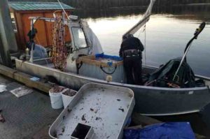 Wildlife trooper conducting initial investigation of Jonathan McGraw's dive vessel in December 2017. Image-AST.