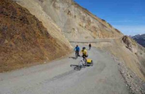 Cyclists ride on an unstable portion of the 92-mile gravel road within Denali National Park. Photo by Ned Rozell