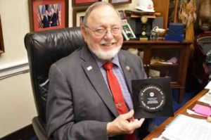 Congressman Don Young holds his award from the ONE Campaign.