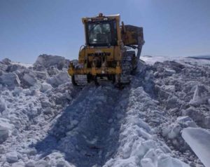 A dozer clears snow from American Summit in April. A DOT&PF crew from the Tok Maintenance District has been working to opening the road since mid-March.