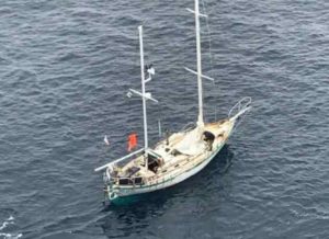 The disabled and adrift 28-foot sailing vessel Miss Lilly is spotted from the deck of motor vessel President Eisenhower, a 984-foot bulk carrier cargo ship, whose master received notification of a 67-year-old man reporting to be disabled and adrift approximately 575 miles south southwest of Dutch Harbor. U.S. Coast Guard courtesy photo.