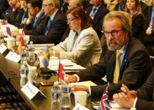 Konrad Steffen, wearing glasses and a yellow tie, at the White House in 2016, where he  represented Switzerland at the first Arctic Ministarial Conference. Image courtesy Swiss Federal Institute for Forest, Snow and Landscape.