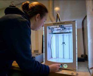 Shalane Regan, a mechanical engineer and researcher with the Coast Guard's Research and Development Center in Connecticut, uses a 3D printer while in the Bering Sea aboard the Coast Guard Cutter Polar Star. U.S. Coast Guard Photo by Petty Officer 1st Class Cynthia Oldham