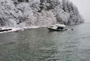 A beached vessel is anchored to the shoreline in Barlow Cove, about 15 miles northwest of Juneau.  (U.S. Coast Guard photo by Cutter Bailey Barco)