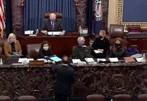 U.S. House lead impeachment manager Jamie Raskin, D-MD, hands over the House article of impeachment against former President Donald Trump, on the floor of the U.S. Senate. Image-Internet video screengrab.