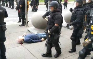 Police officers in Buffalo, New York walk by the motionless body of 75-year-old Martin Gugino as he bleeds from his ear after being attacked by officers during a protest on June 5, 2020. (Photo: Screengrab/WBFO)